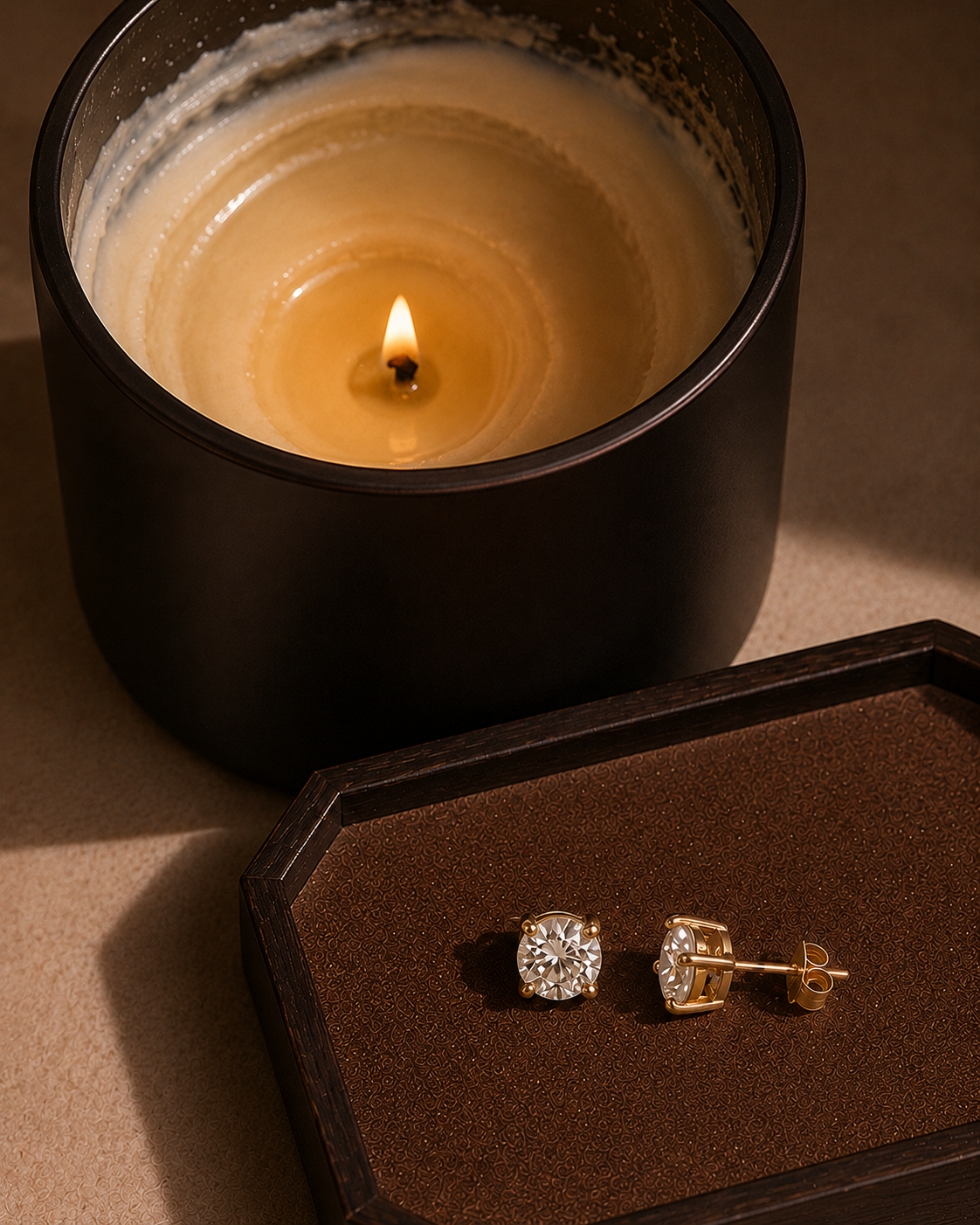 Burned Luxe Reveal candle with melted wax and revealed jewelry earrings
