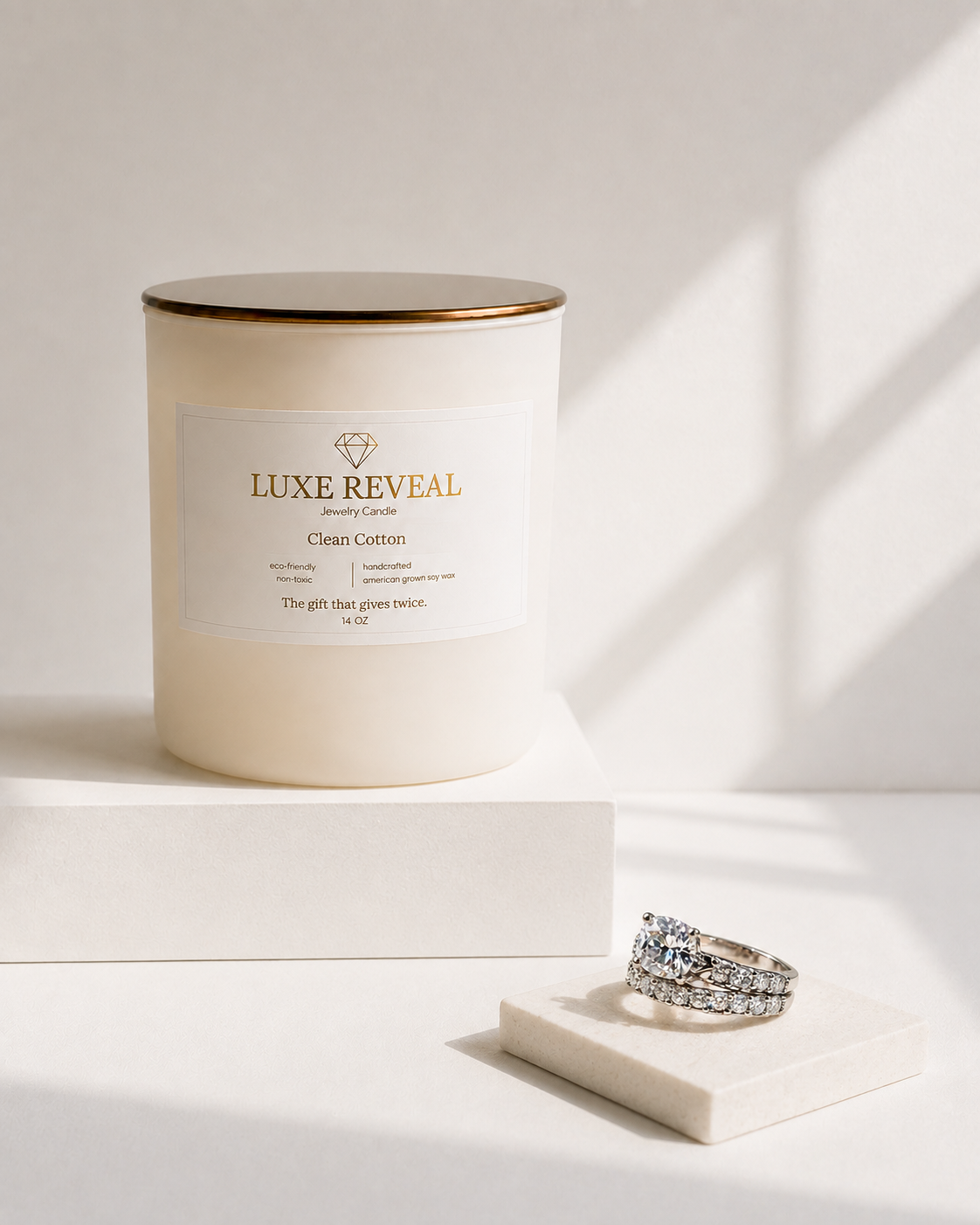 Clean Cotton Luxe Reveal candle with the revealed diamond ring set beside it
