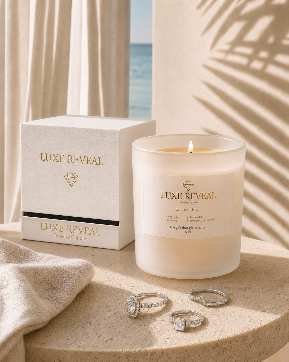 Coconut Bay Luxe Reveal candle with a delicate diamond ring displayed on a stone slab beside it