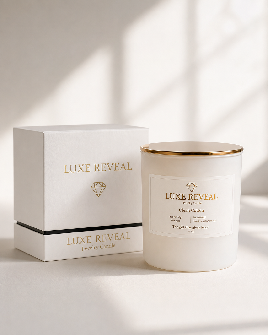Clean Cotton Luxe Reveal candle beside its white Luxe Reveal gift box