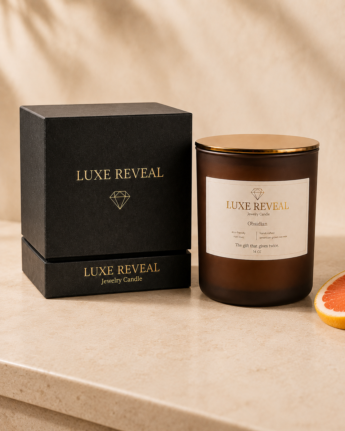 Obsidian Luxe Reveal candle beside the closed black Luxe Reveal gift box